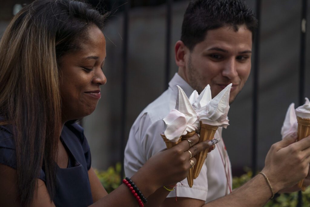 a man and a woman eating ice cream cones