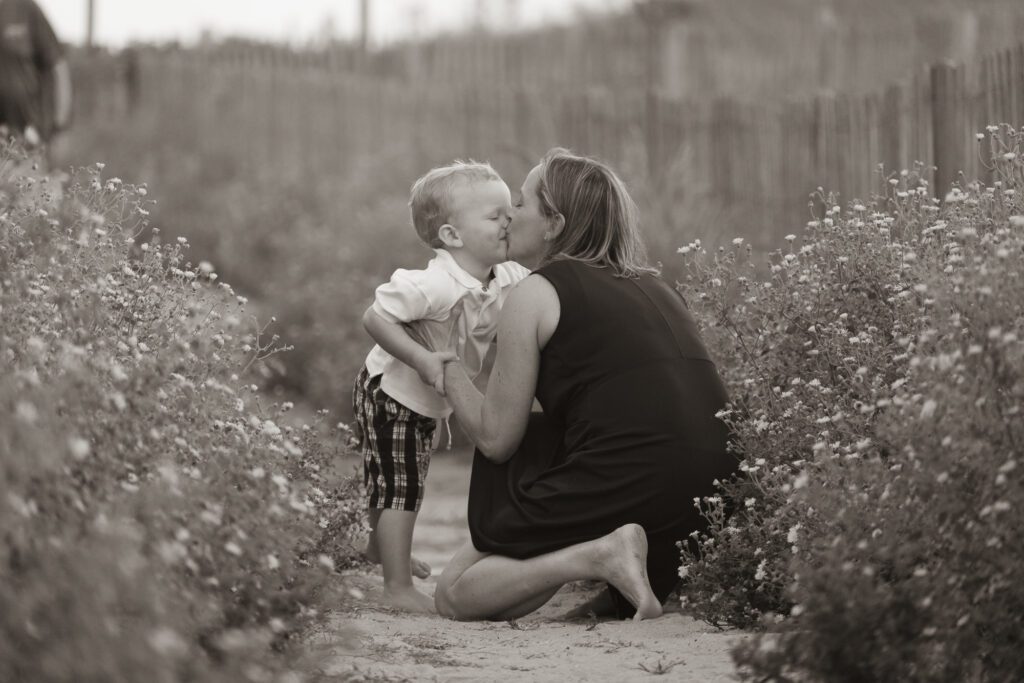 a woman kissing a small child on the cheek