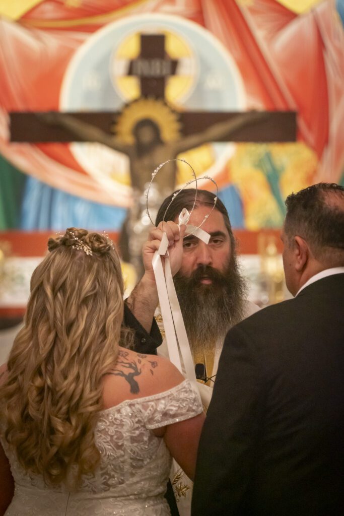 a man and a woman standing in front of a cross