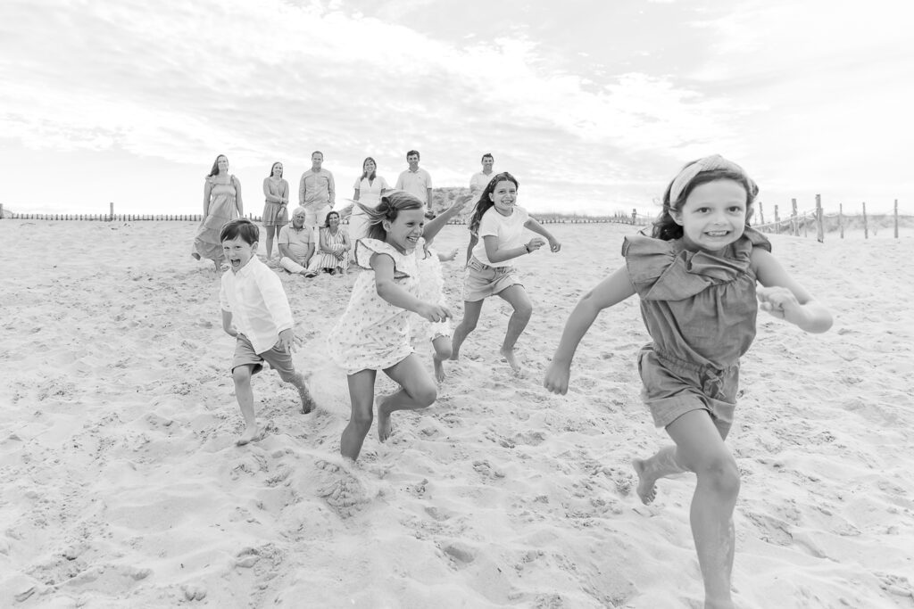 a group of children running on a beach