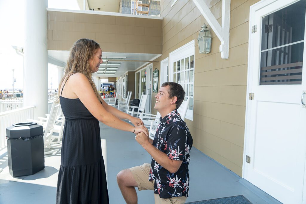 a man and a woman shaking hands on a porch