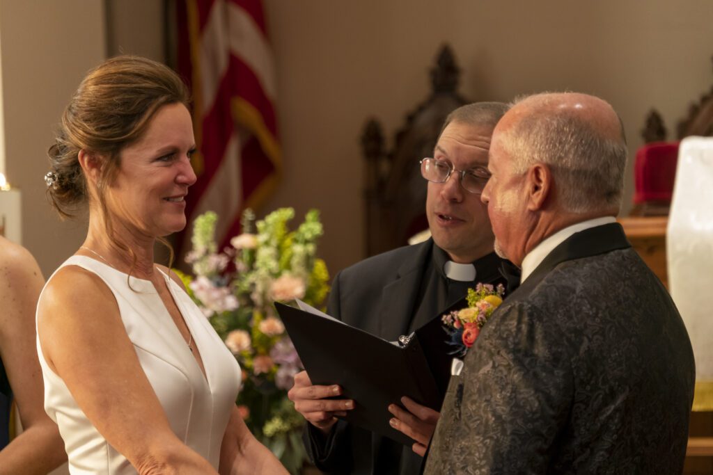 a bride and groom exchanging vows in a church