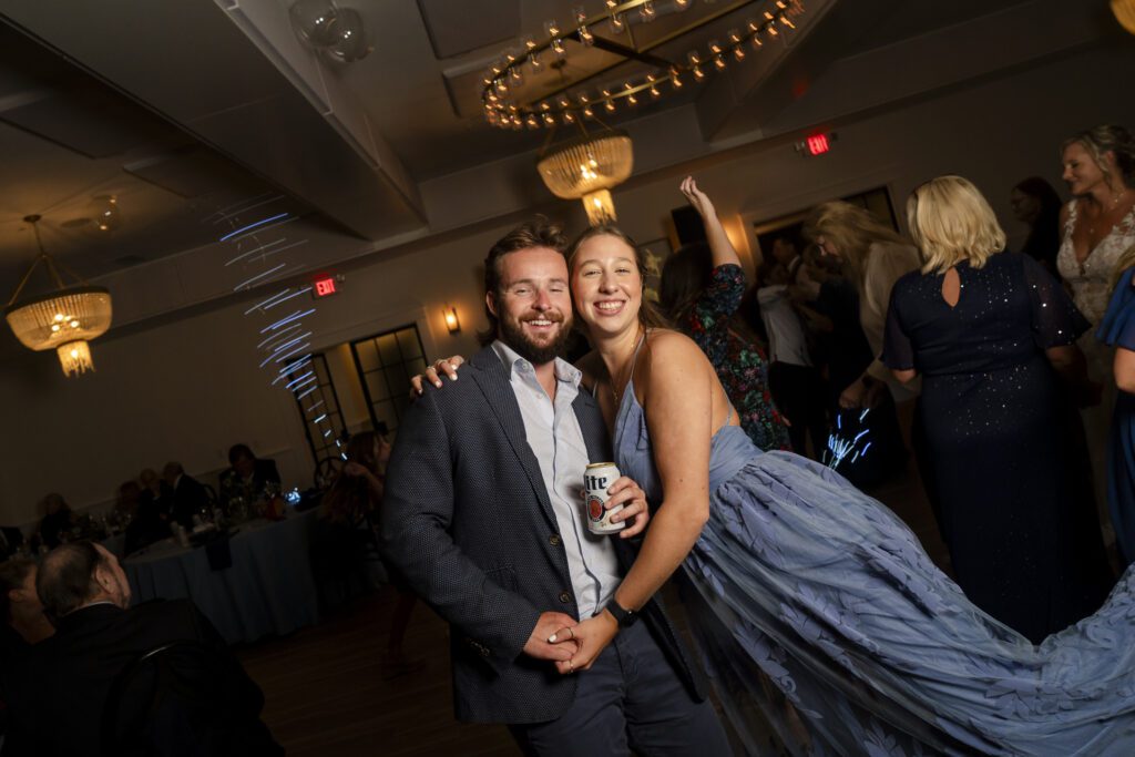 a man and woman pose for a picture on the dance floor