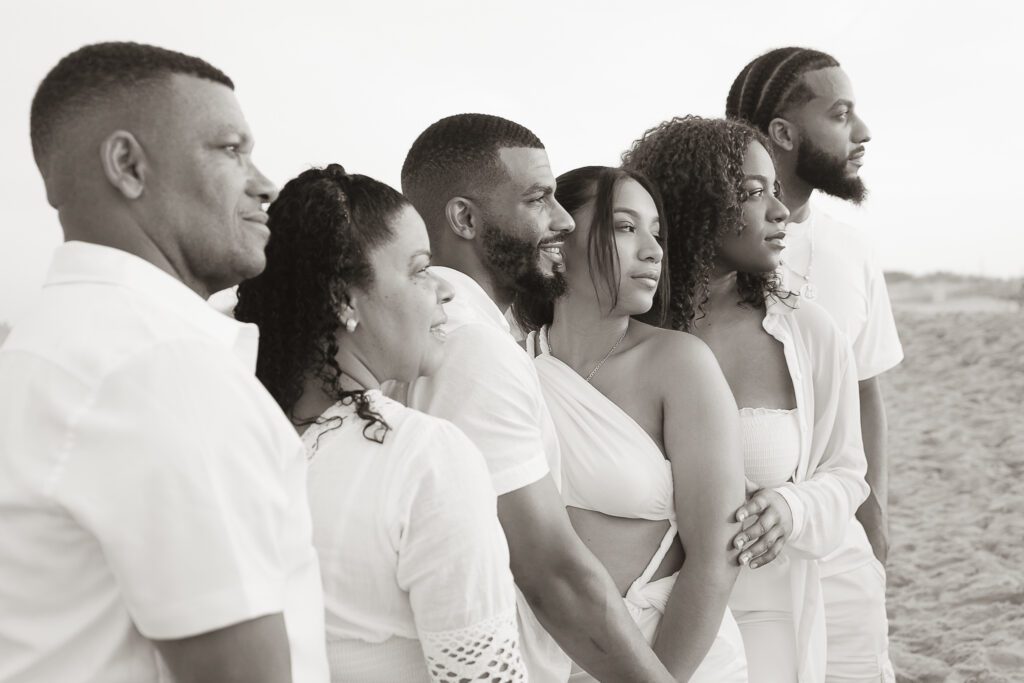 a group of people standing next to each other on a beach