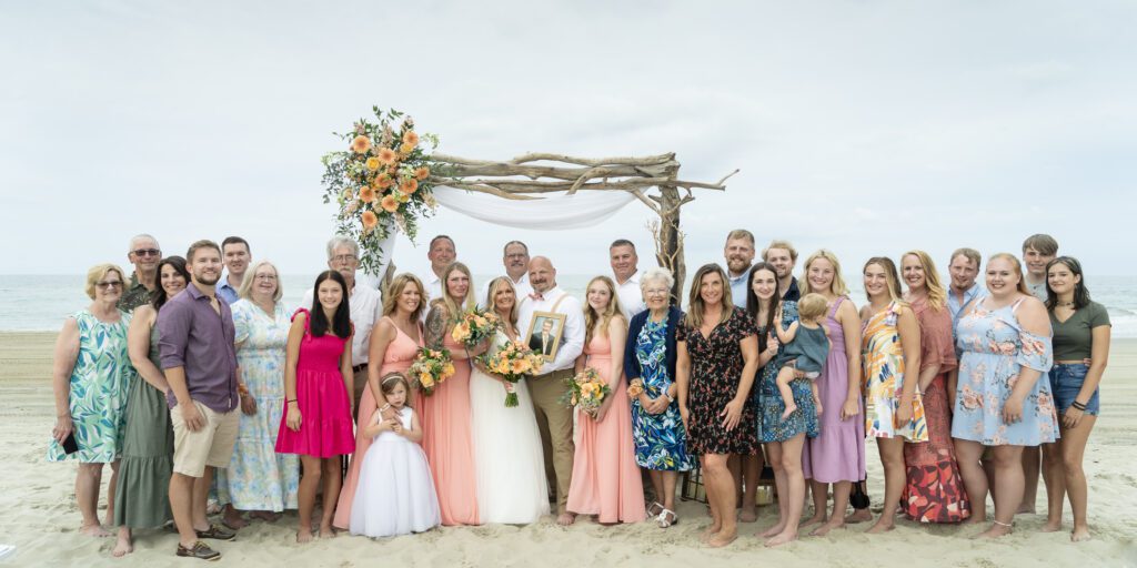 a group of people standing on top of a sandy beach