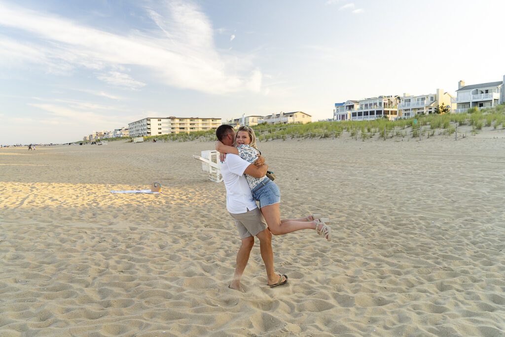 a man carrying a woman on the beach