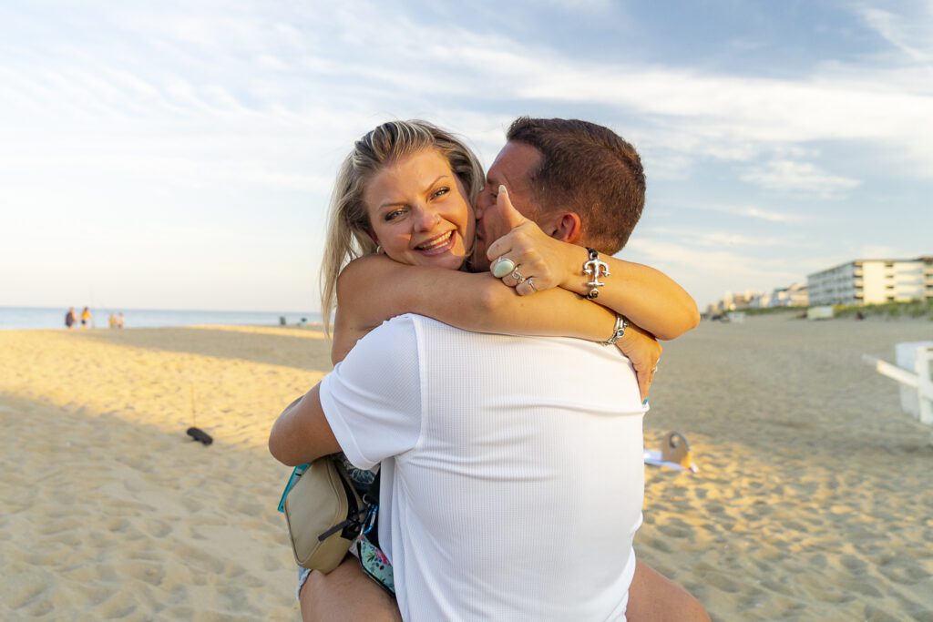 a man hugging a woman on the beach