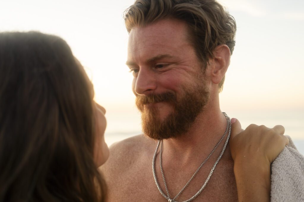 a man and a woman standing on a beach