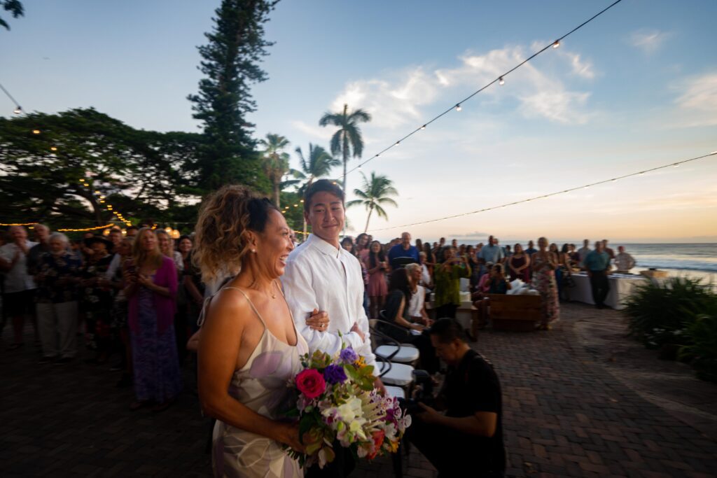 a man and a woman standing next to each other in front of a crowd of