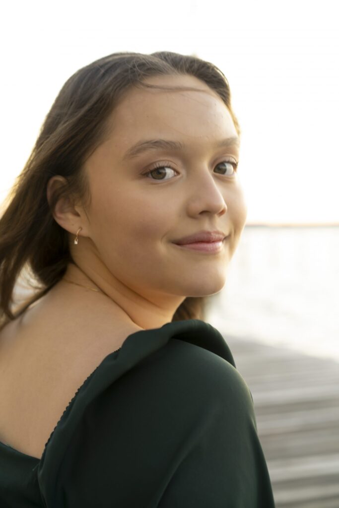 a woman in a green dress posing for a picture